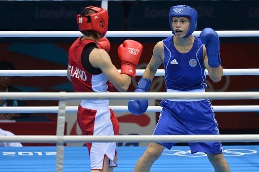 Katie Taylor of Ireland (in red) defends against Sofya Ochigava of Russia
